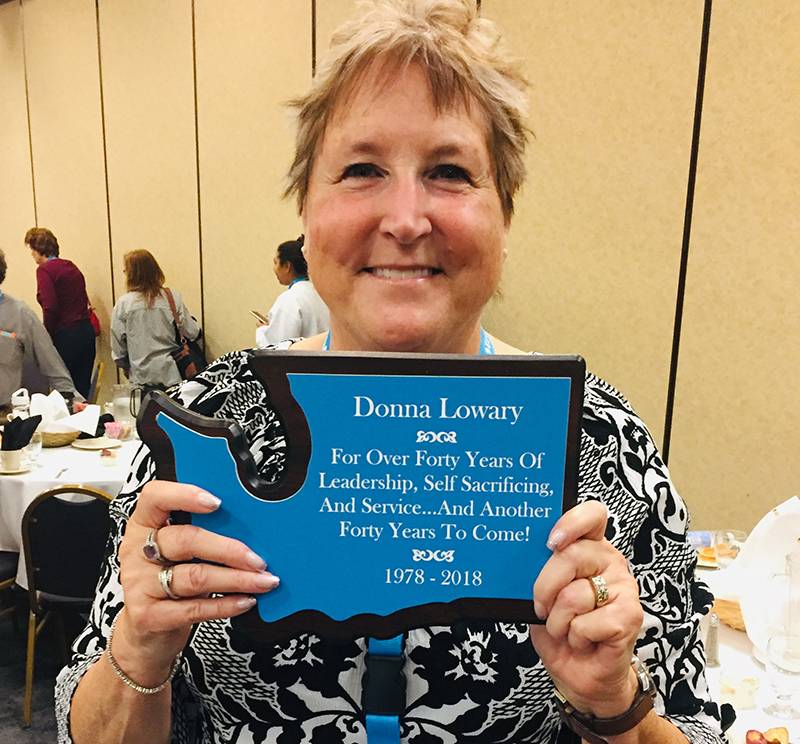 Photo of Donna with her retirement plaque. 